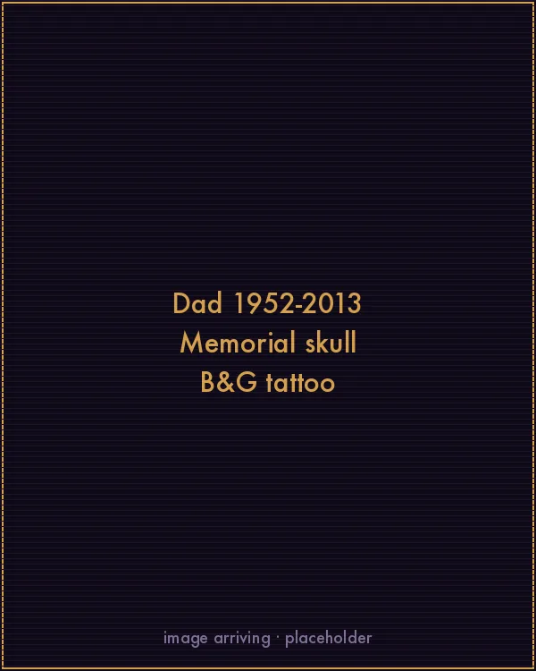 Black and grey memorial tattoo by Kevin Mokuahi — flowing-haired skull with banner reading Dad 1952-2013