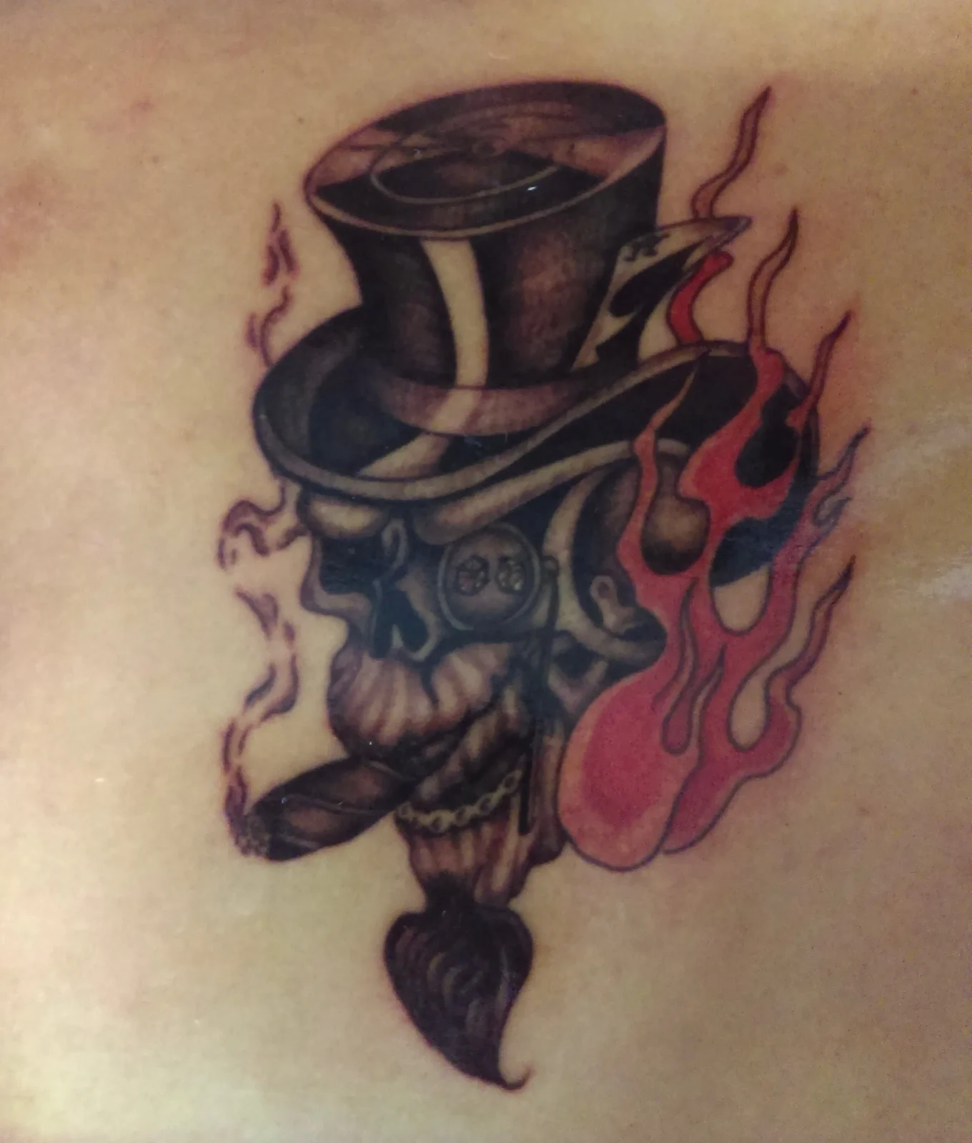 Top-hat skull chest tattoo by Kevin Mokuahi