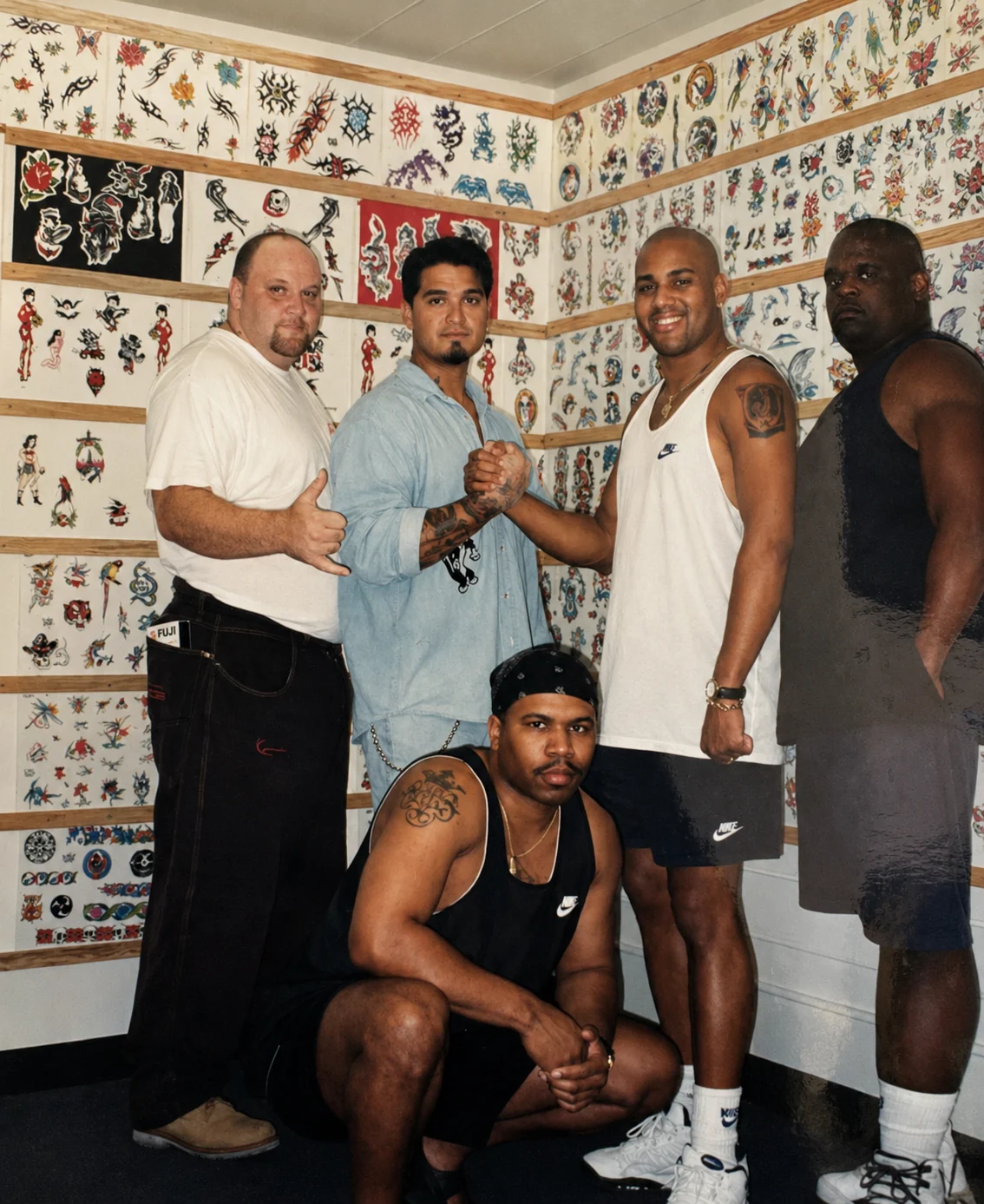 U.N.V. boyband members posing at the Skin Deep Waikiki flash wall with Kevin Mokuahi and John Boy Gomes during a Waikiki visit, late 1990s